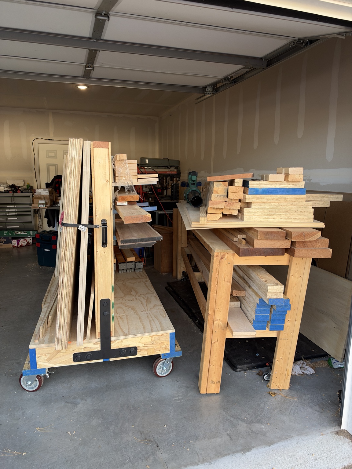 Loaded mobile lumber cart with sheet goods, open end, black T-strap and handle in Loren's garage